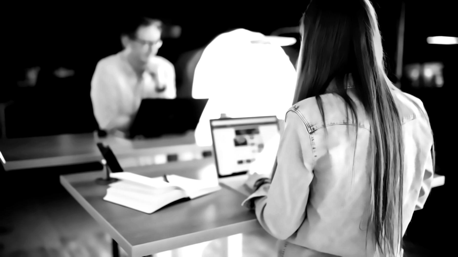 Business professional reviewing market analysis data on multiple screens
